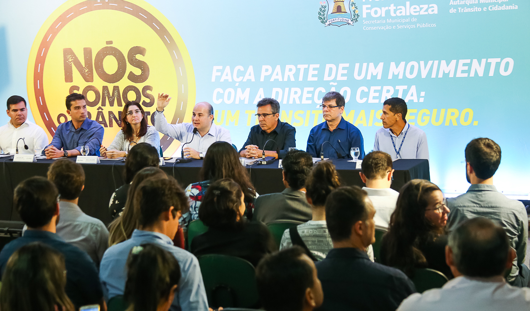 várias pessoas numa mesa de palestra